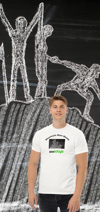 Unisex t-shirt with 'Mountain Man Moves' slogan, styled for outdoor adventures and dance challenges – set against a bold, mountainous backdrop.