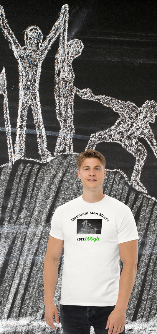 Unisex t-shirt with 'Mountain Man Moves' slogan, styled for outdoor adventures and dance challenges – set against a bold, mountainous backdrop.