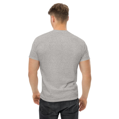 Unisex t-shirt with 'Mountain Man Moves' slogan, styled for outdoor adventures and dance challenges – set against a bold, mountainous backdrop.