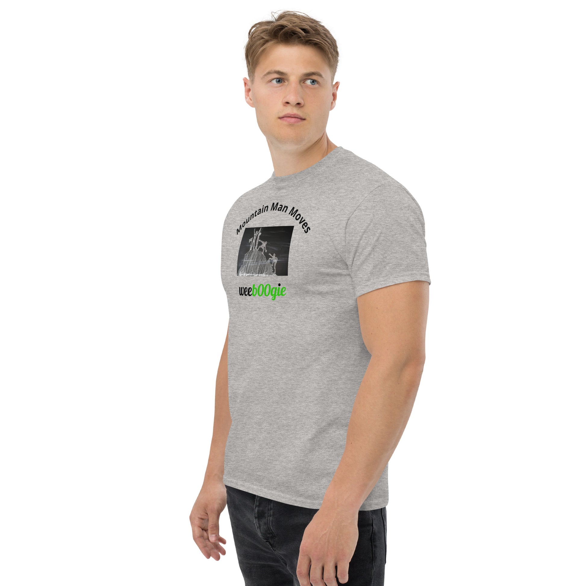 Unisex t-shirt with 'Mountain Man Moves' slogan, styled for outdoor adventures and dance challenges – set against a bold, mountainous backdrop.