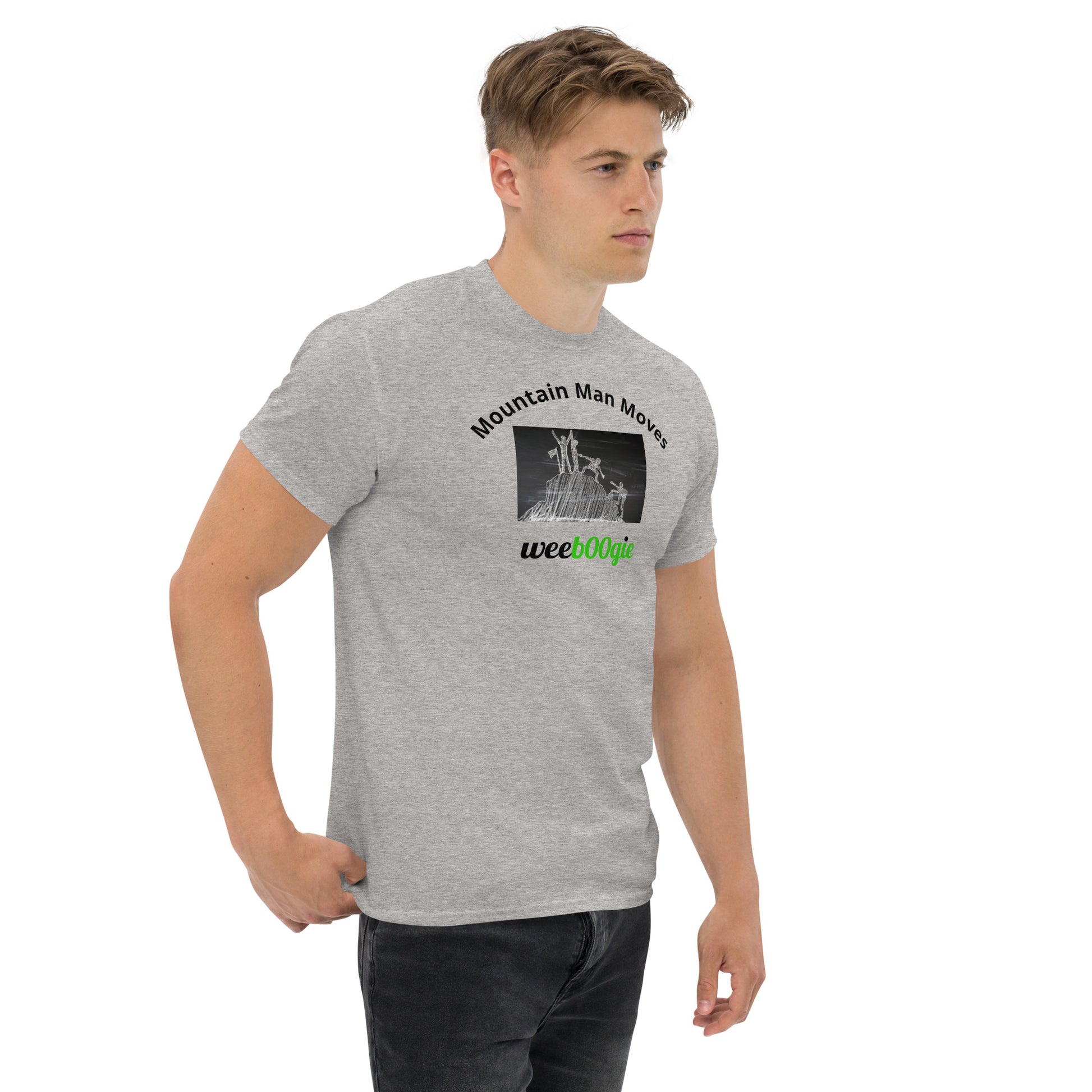 Unisex t-shirt with 'Mountain Man Moves' slogan, styled for outdoor adventures and dance challenges – set against a bold, mountainous backdrop.